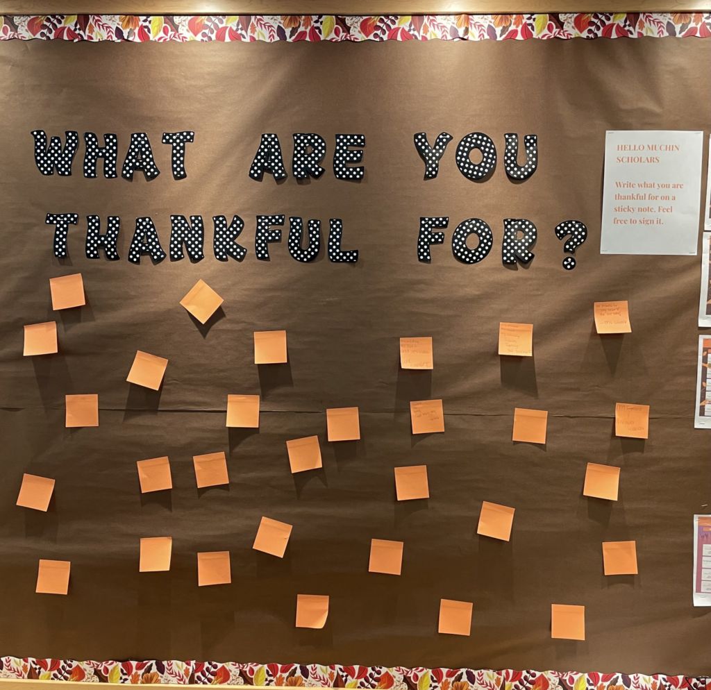 Photo shows Thanksgiving bulletin board decorated with notes of gratitude from Muchin College Prep students, teachers and staff