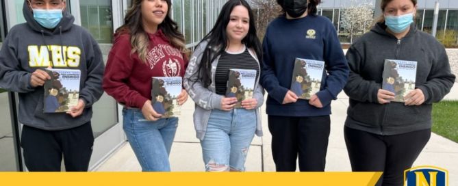 Photo shows Mansueto High School students posing with the graphic novel "They Called Us Enemy" or "Nos Llamaron Enemigo" by George Takei