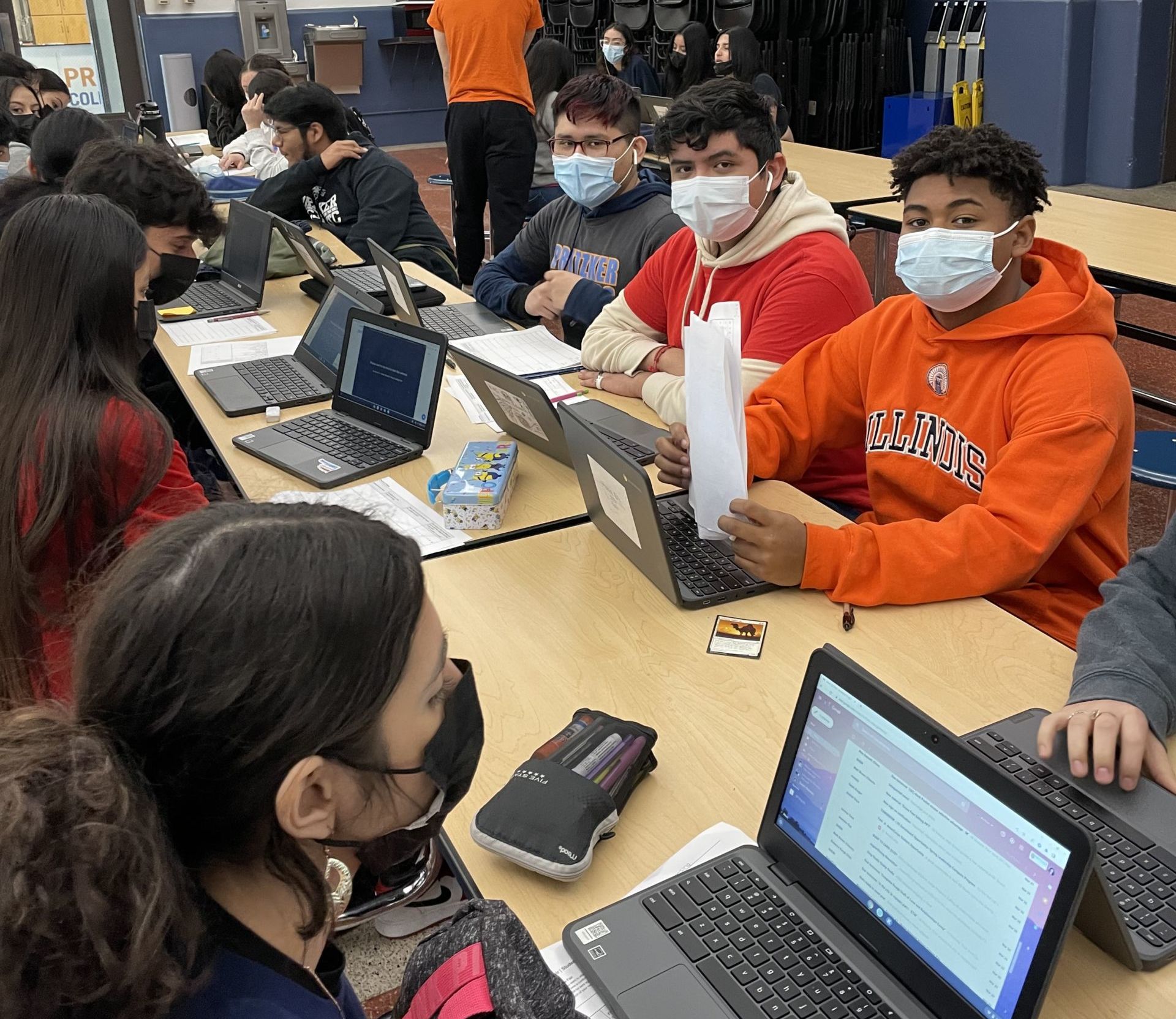 Photo shows students at Pritzker College Prep attending Noble Schools' 13th annual College Fair on their laptops in the classroom