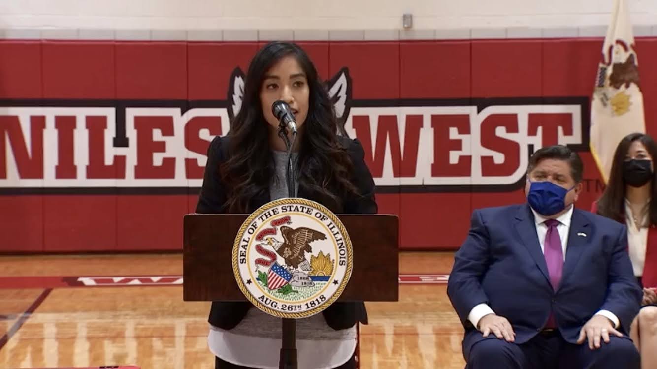 Photo shows Laura Houcque, Rauner College Prep college counselor, speaking at the TEAACH Act signing ceremony.