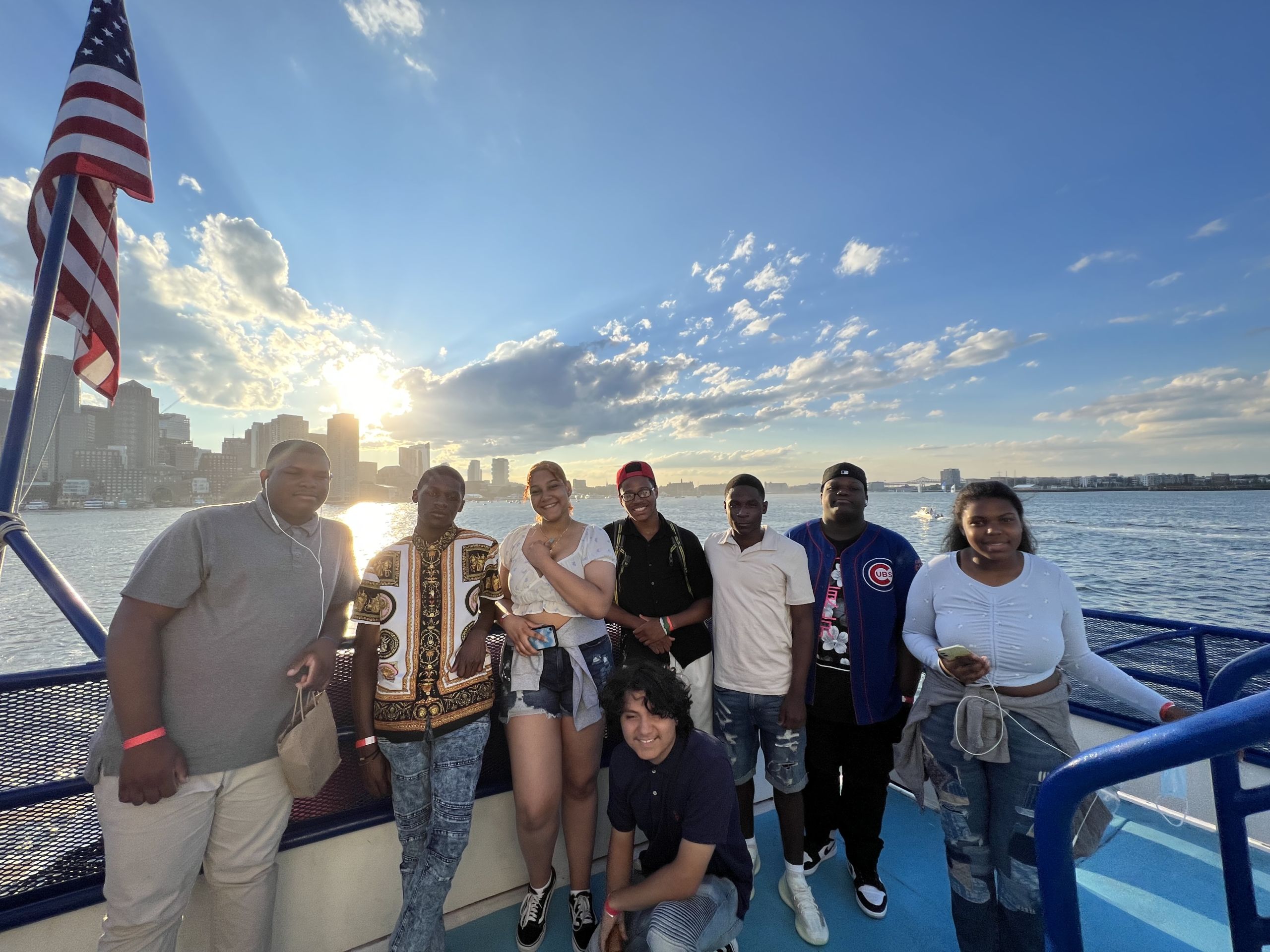 Photo shows Brianna Dekrines and her Baker College Prep peers on a boat in Boston Harbor during their visit to Harvard University