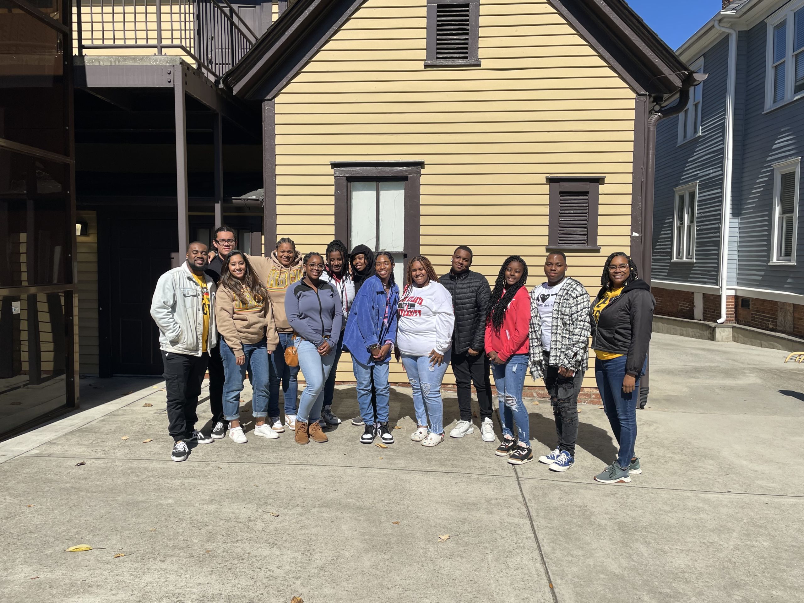 Image of 13 students visiting historic Black colleges in front of a home