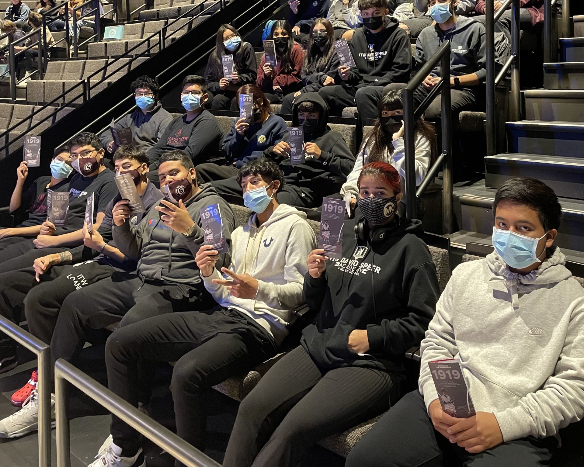 Performing Arts Image shows ITW David Speer Academy students in the performing arts class taking a field trip to the Steppenwolf Theater. In this photo, they are sitting in the audience, getting ready to watch the play 1919, which is adapted from Chicago poet Eve Ewings writings.