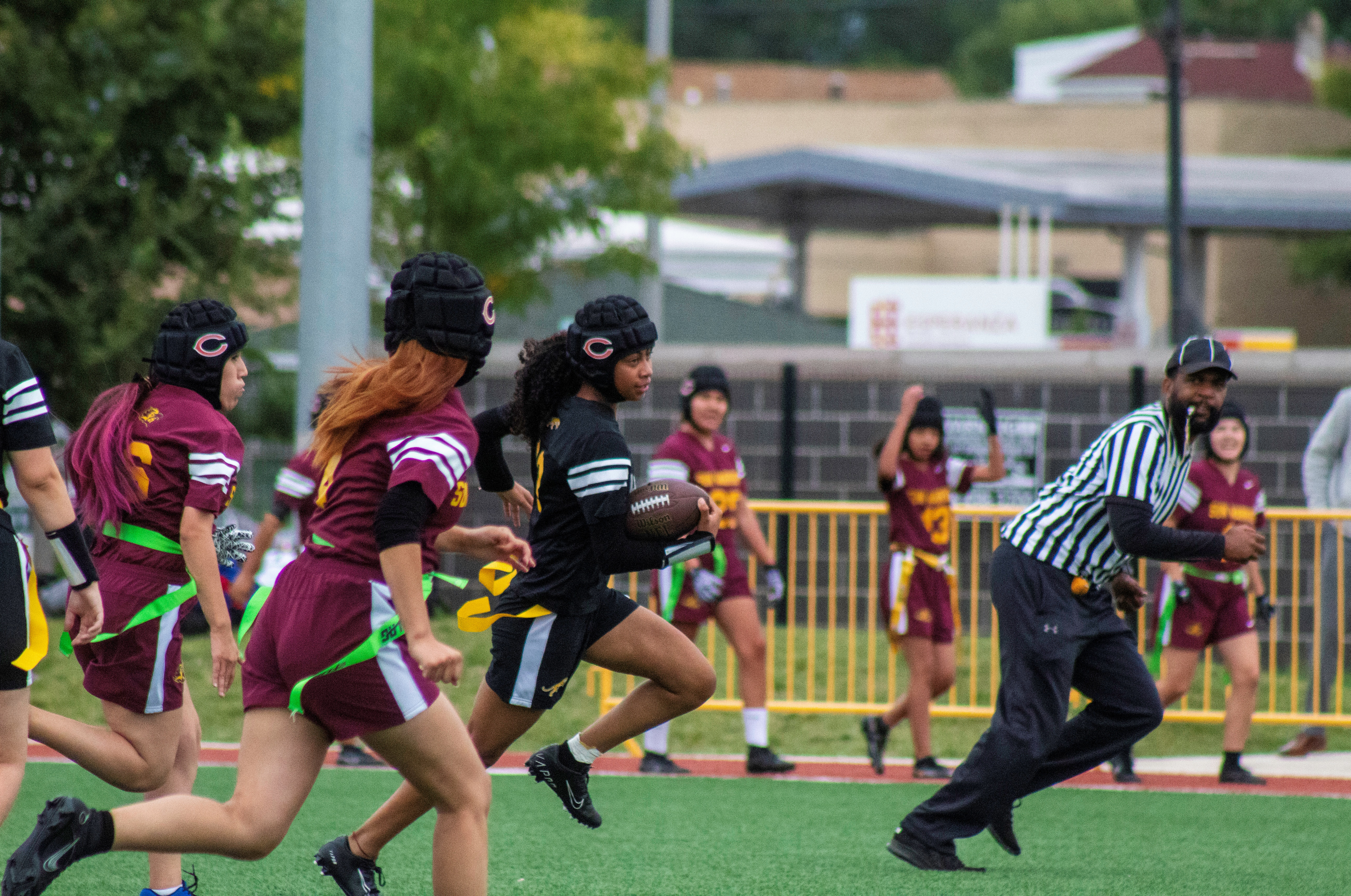 Image shows Mansueto High School flag football athlete and junior Serenity Hodges making a break away from the opposing defense on her way to a touchdown.
