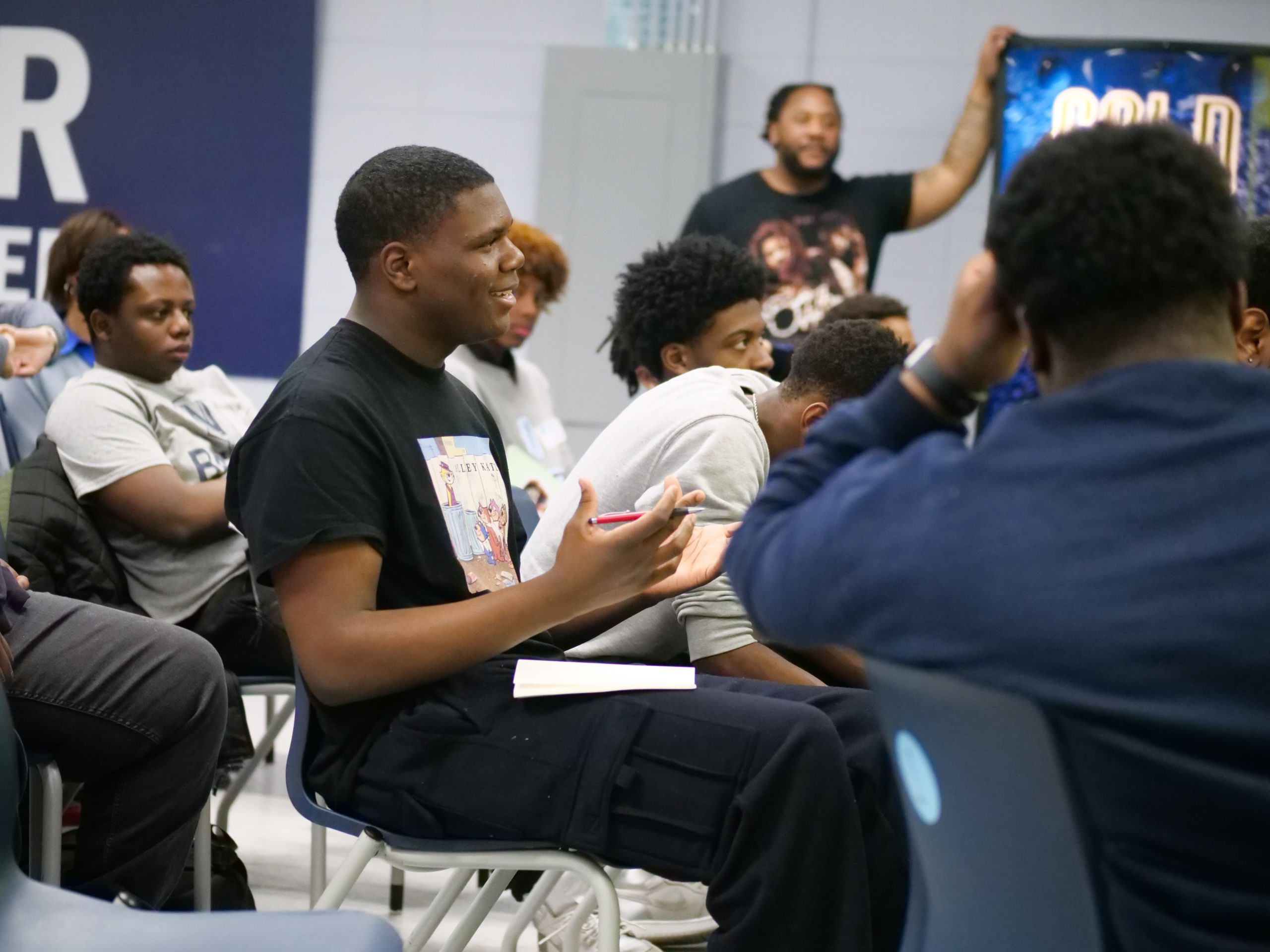 Photo shows a student at Baker College Prep, taking notes on how to start his own circle to support his peers and their mental health during the Black Boys Heal: See Me, Hear Me event.