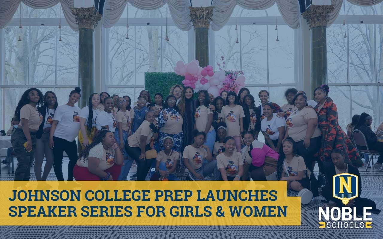 In this graphic, there is an image in the background that shows a bunch of Johnson College Prep girls and staff posing at the Women's Empowerment Brunch with Noble Schools' CEO Constance Jones in the center. There are big bay windows behind the group and a photobooth set up with a green grass backdrop and pink balloons. On top of the photo, there is a transparent dark blue layer. On top of that and in the bottom left corner, there is blue text on a yellow box that reads "Johnson College Prep Launches Speaker Series for Girls & Women". In the bottom right corner is the Noble Schools logo.
