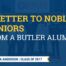 Graphic shows a faint image in the background of a few students and a staff member standing in front of the entrance to Butler College Prep. On top of it is a transparent dark blue layer. On top of that is yellow and white bold text that reads "A Letter to Noble Seniors from a Butler Alum". In the bottom left corner, there is a white ribbon fringed with yellow on the end. There is blue text in this ribbon that reads "By Latonya Anderson | Class of 2017". The Noble Schools logo is in the bottom right corner.