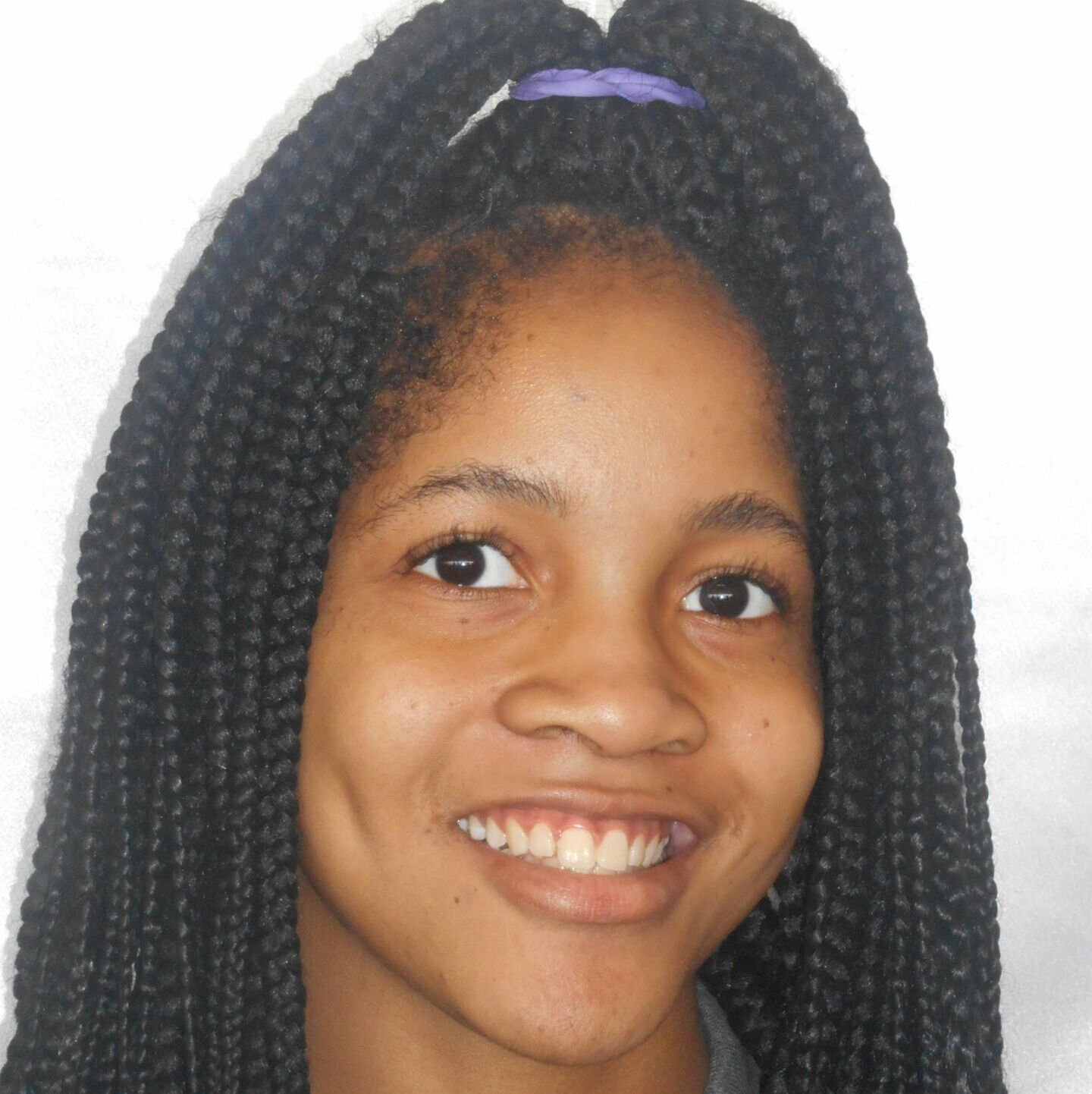 Photo shows a high school headshot of Latonya Anderson, a Class of 2017 alum of Butler College Prep. She is a young Black woman with long dark brown hair. In this photo, her hair is straight and put up in a half-part. She is wearing a dark gray polo shirt.