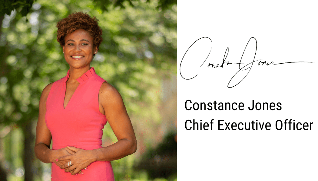 Photo shows a headshot of Constance Jones, CEO of Noble Schools, in a bright pink dress outside among green plants. She is a Black woman with short curly hair. To the right of the headshot is her signature with word below it that read "Constance Jones, Chief Executive Officer"
