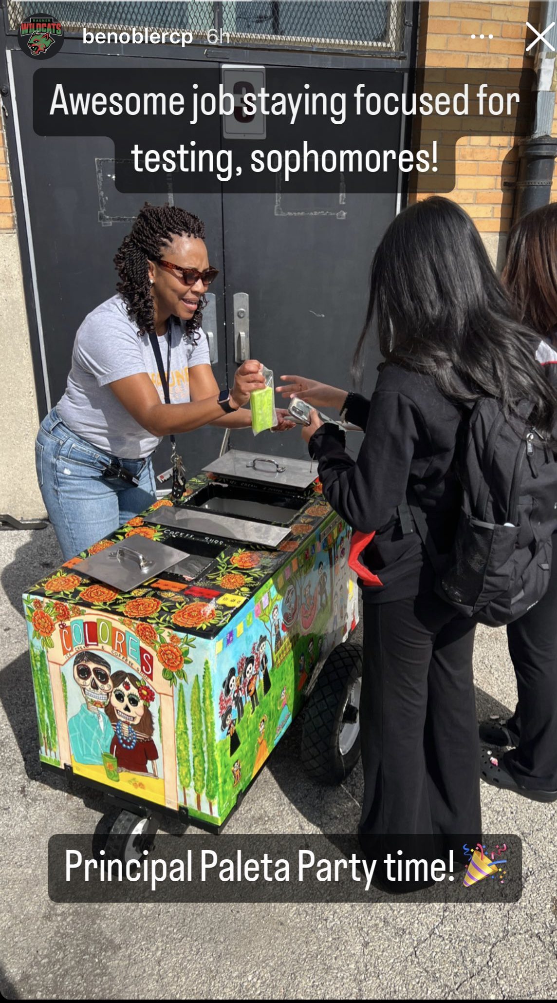 Bennett standing a a table passing out icecream to her students