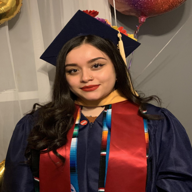 A photo of Jocelyn Murillo with her college graduation robes on.