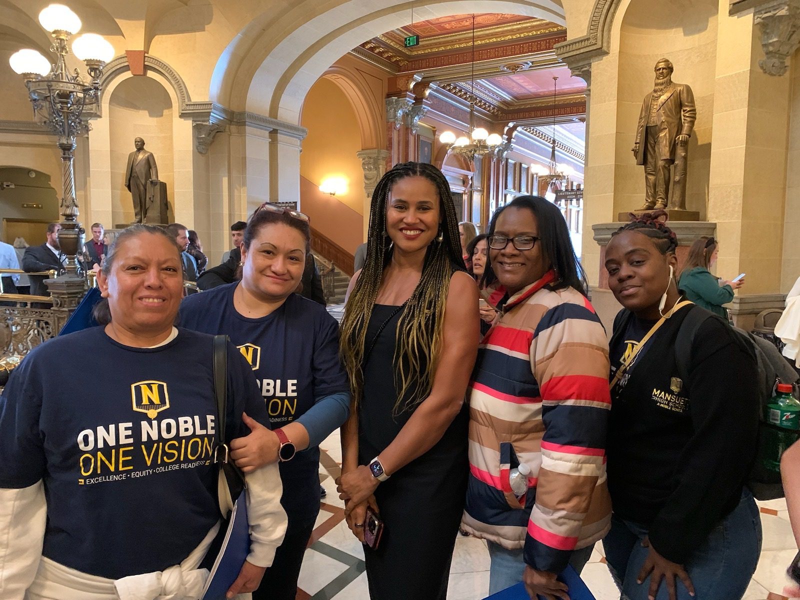 This photo shows Noble Schools' CEO Constance Jones with Noble parents in the State Capitol building in Springfield.
