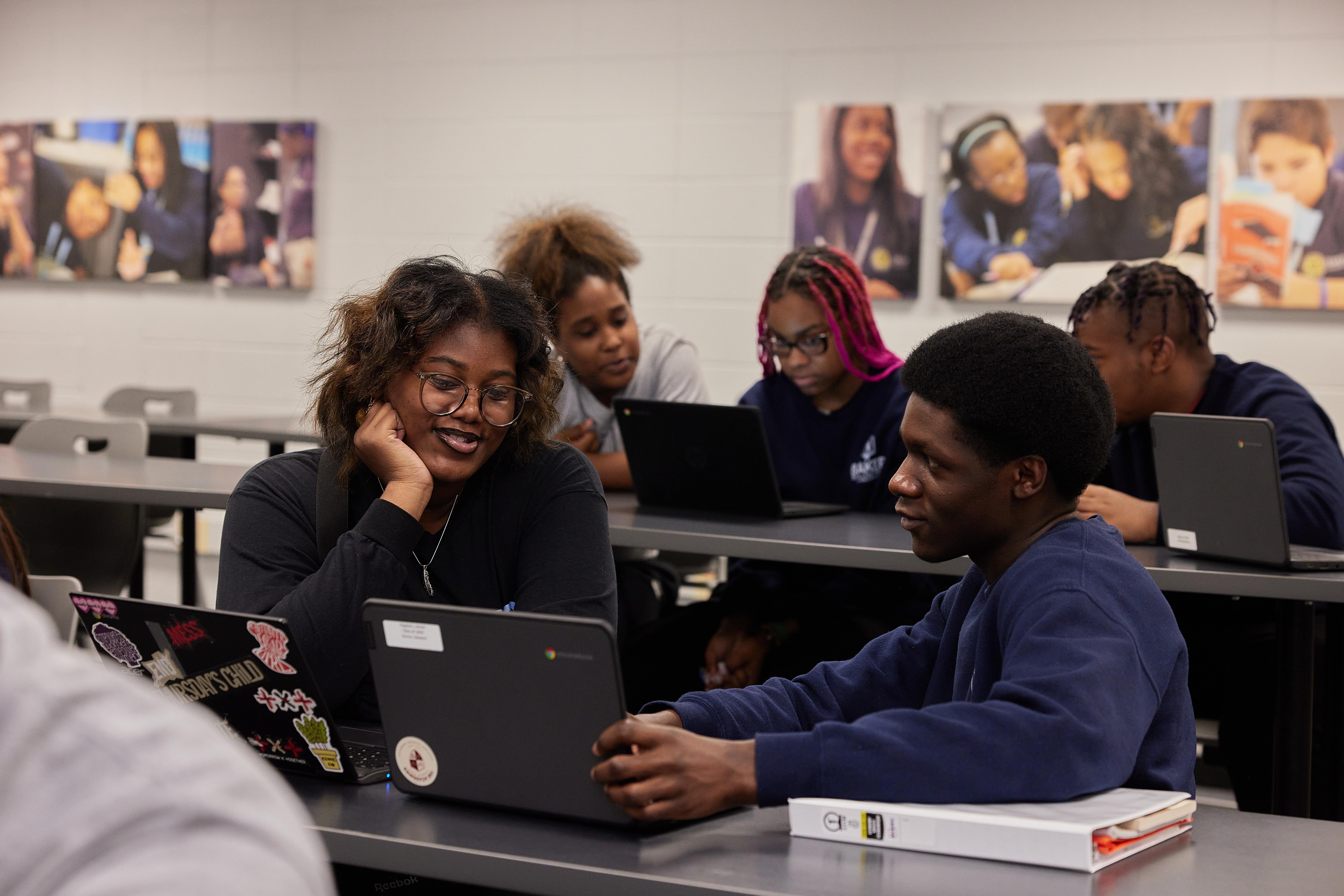 Baker College Prep students looking at their computer together