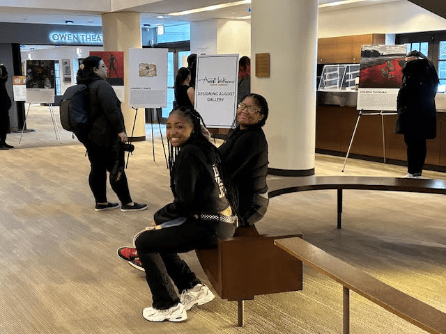 J'maria and N'yana sit together at the deign gallery
