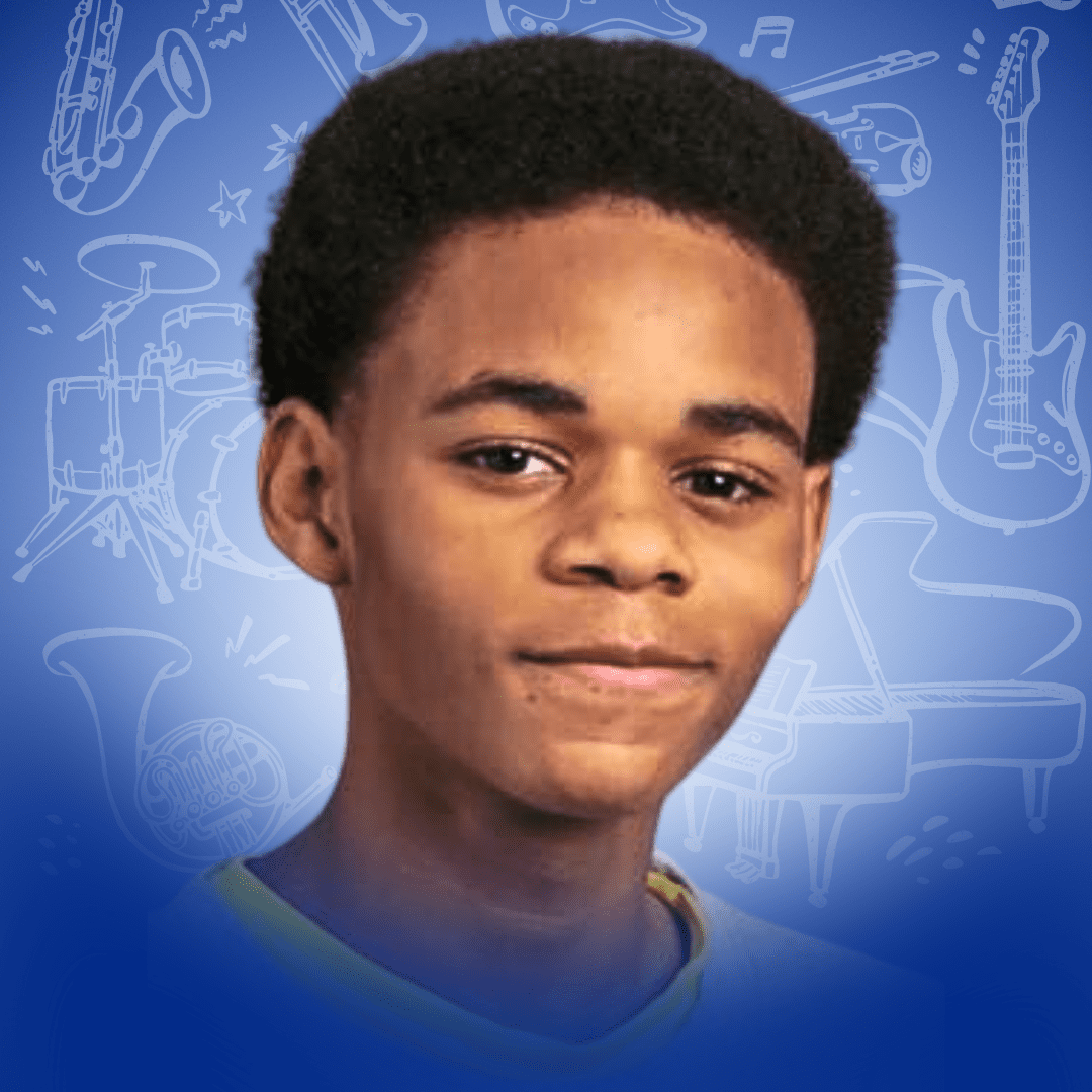 Professional headshot of Karlito Franklin, a sophomore at Johnson College Prep. He has light brown skin, short brown hair, and is smiling slightly. The background is blue and has sketches of musical instruments on it.