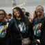 Three Rowe-Clark Math & Science Academy students smile and pose at the HBCU College Fair. They are all wearing matching black sweatshirts with the Rowe-Clark mascot next to the letters HBCU.