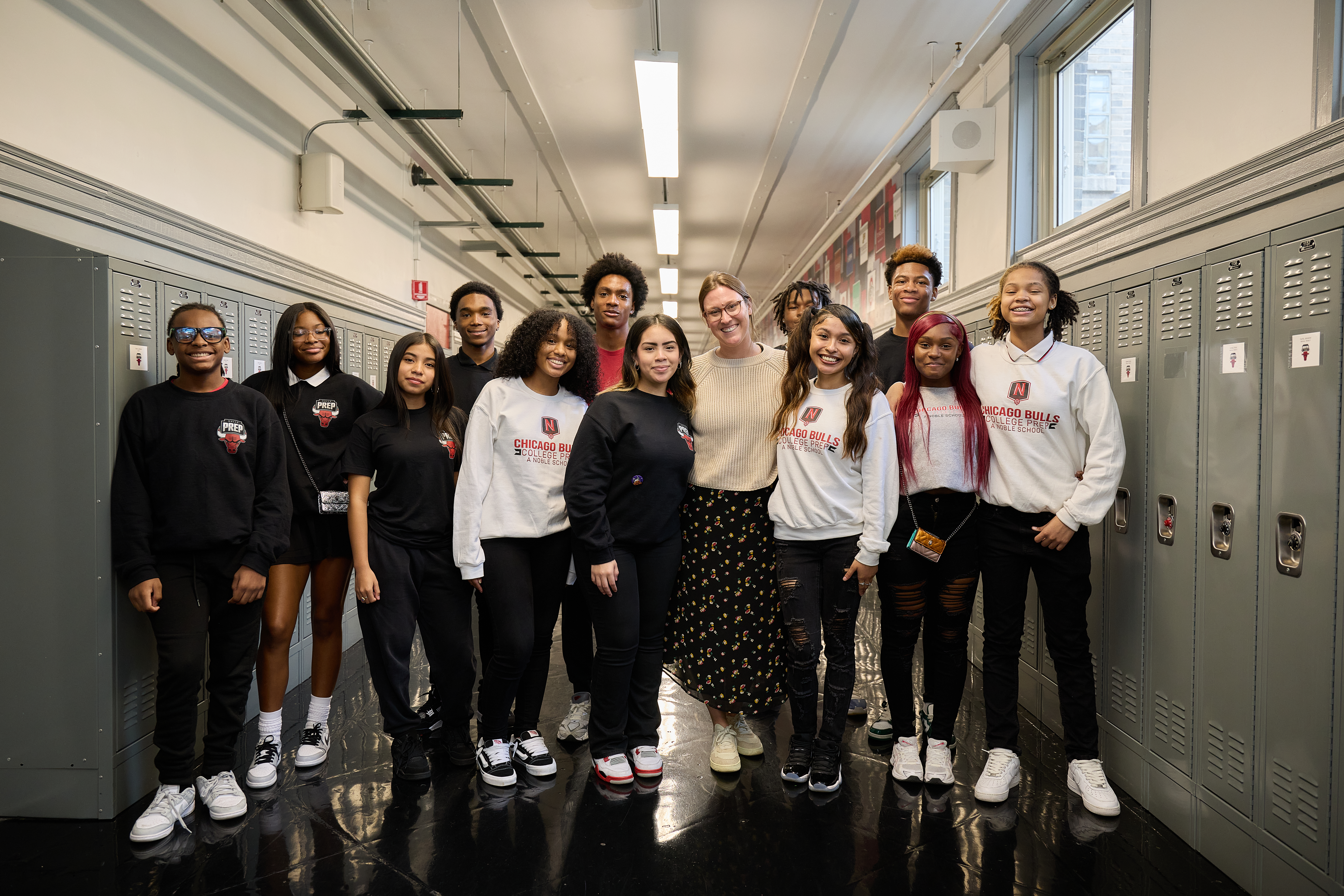 _LM_1452 Chicago Bulls College Prep happy students with a teacher in the hallway
