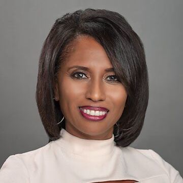 LEAP Innovations Exec Port Phyllis Lockett 080218 A headshot of Phyllis Lockett. She is a woman with straight brown hair in a bob and brown skin. She is smiling and wearing a high-necked, professional white blouse. The background behind her is a non-descript gray.