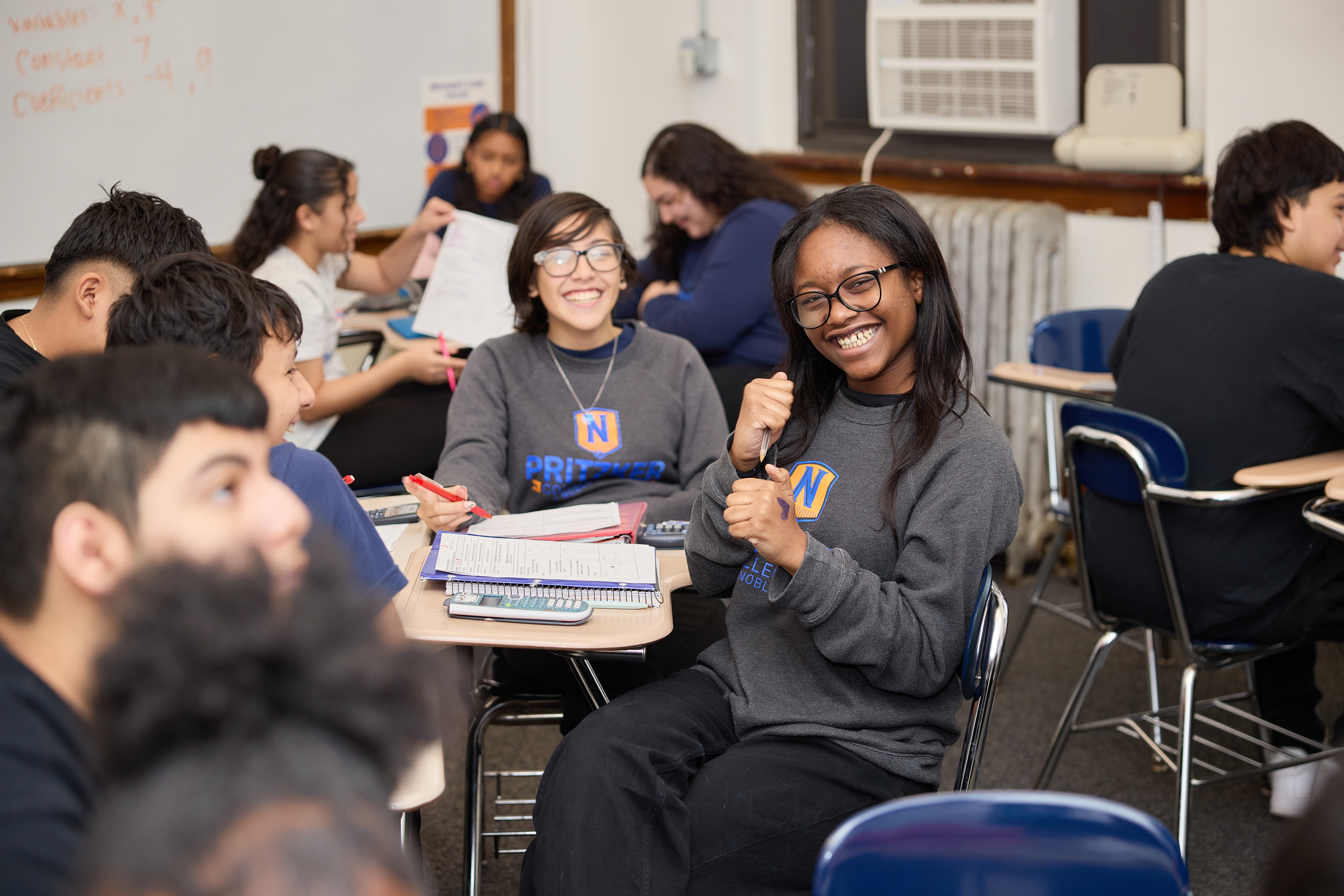 Students smiling and enjoying class at Pritzker College Prep Charter High School in Chicago