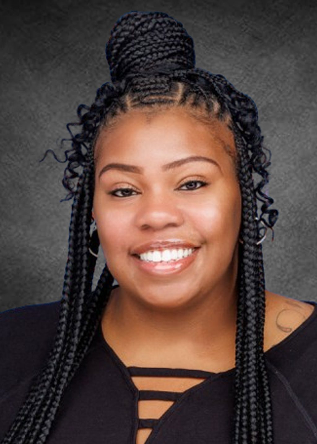 Dana La Rue DLF Cohort 2025 Headshot of Dana La Rue. She is a Black woman and long black locs that go down below her shoulders a loc bun and curly hair coming down the sides. She is smiling and wearing round earings and a black shirt top.