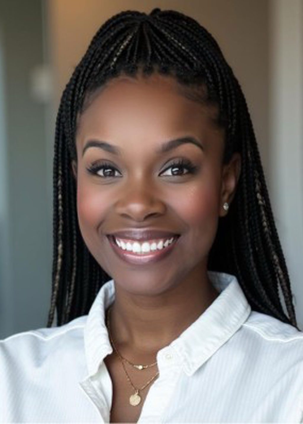 Elisha Simon DLF Cohort 2025 Headshot of Elisha Simon. She is a Black woman and long black locs that go down her back. She is smiling and wearing a white business shirt.