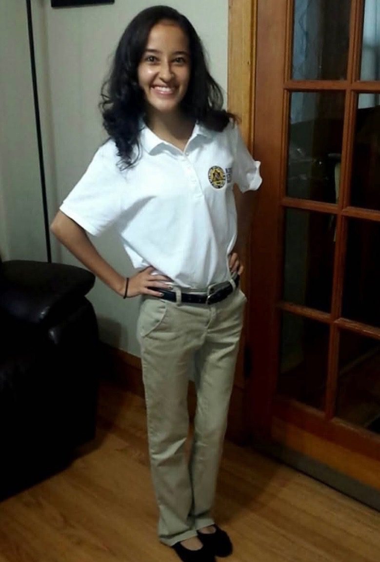 Screenshot Jai stands in her house with her Noble Street College Prep uniform on. She's smiling and has her hands on her hips, like she's ready to take on the year.