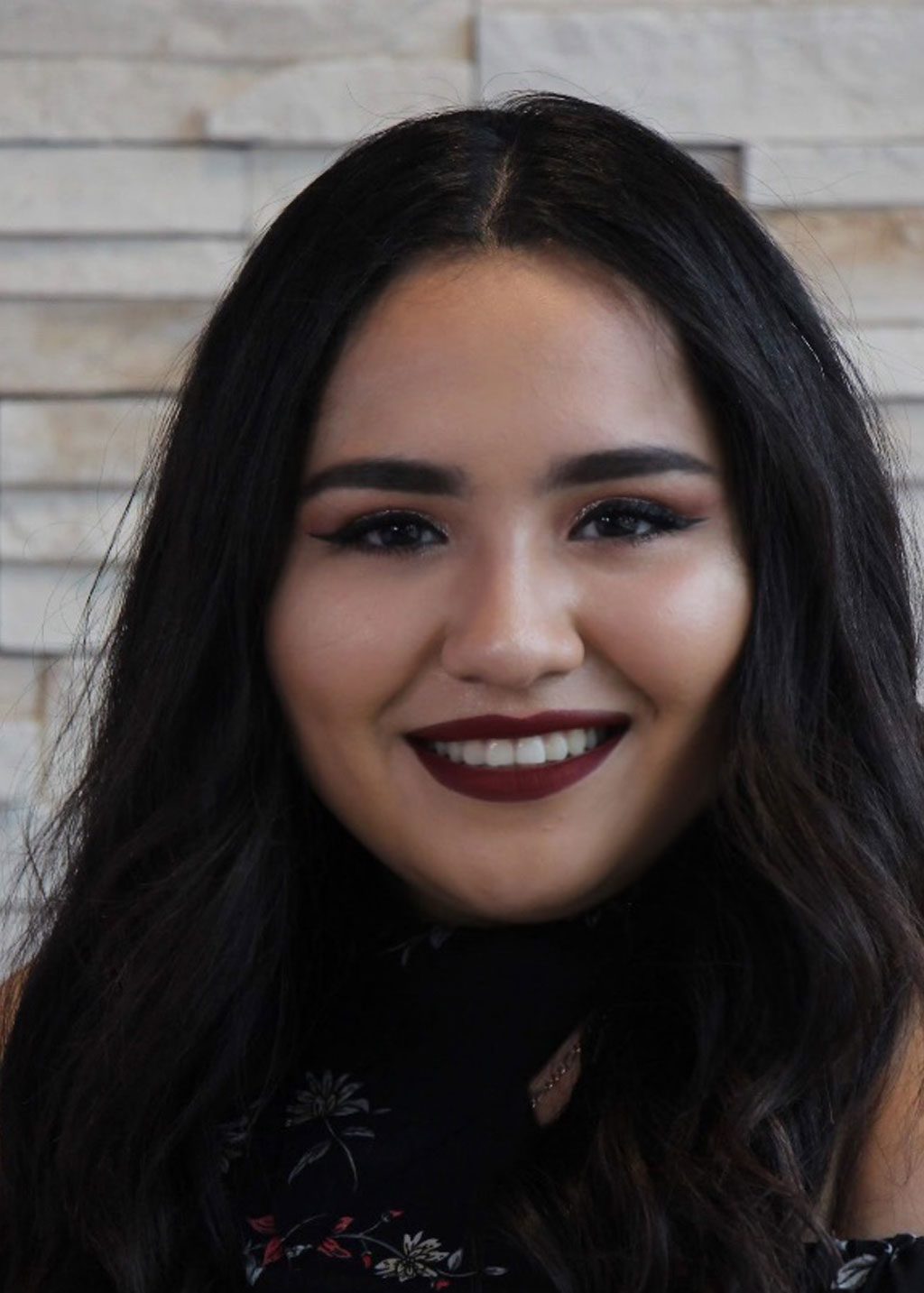 Jasmine Delgado DLF Cohort 2025 Headshot of Jasmine Delgado. She is a Hispanic woman and short shoulder length black hair. She is smiling and wearing a black flower patterned top.