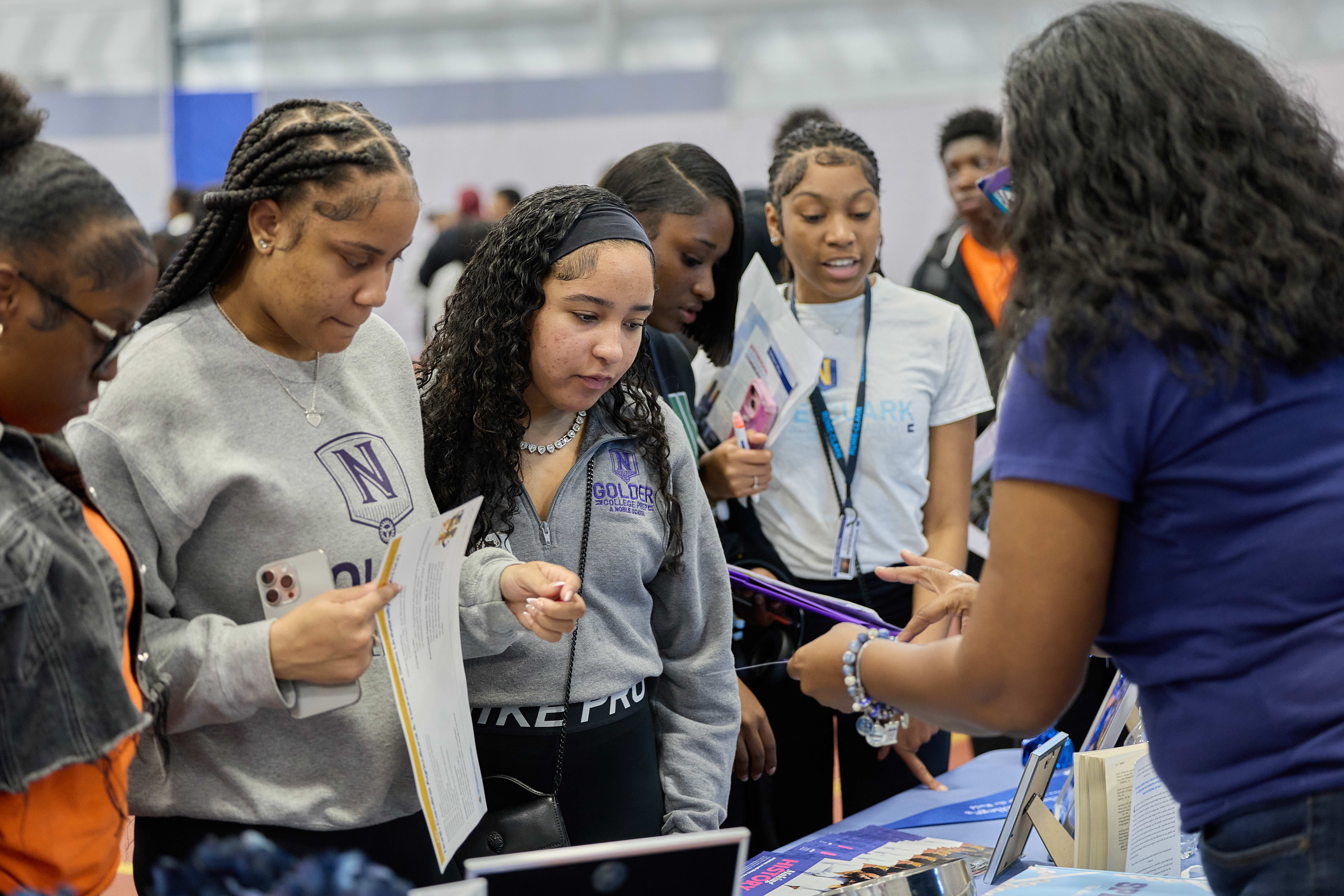 Golder College Prep students talking with a college representative at the HBCU College Fair