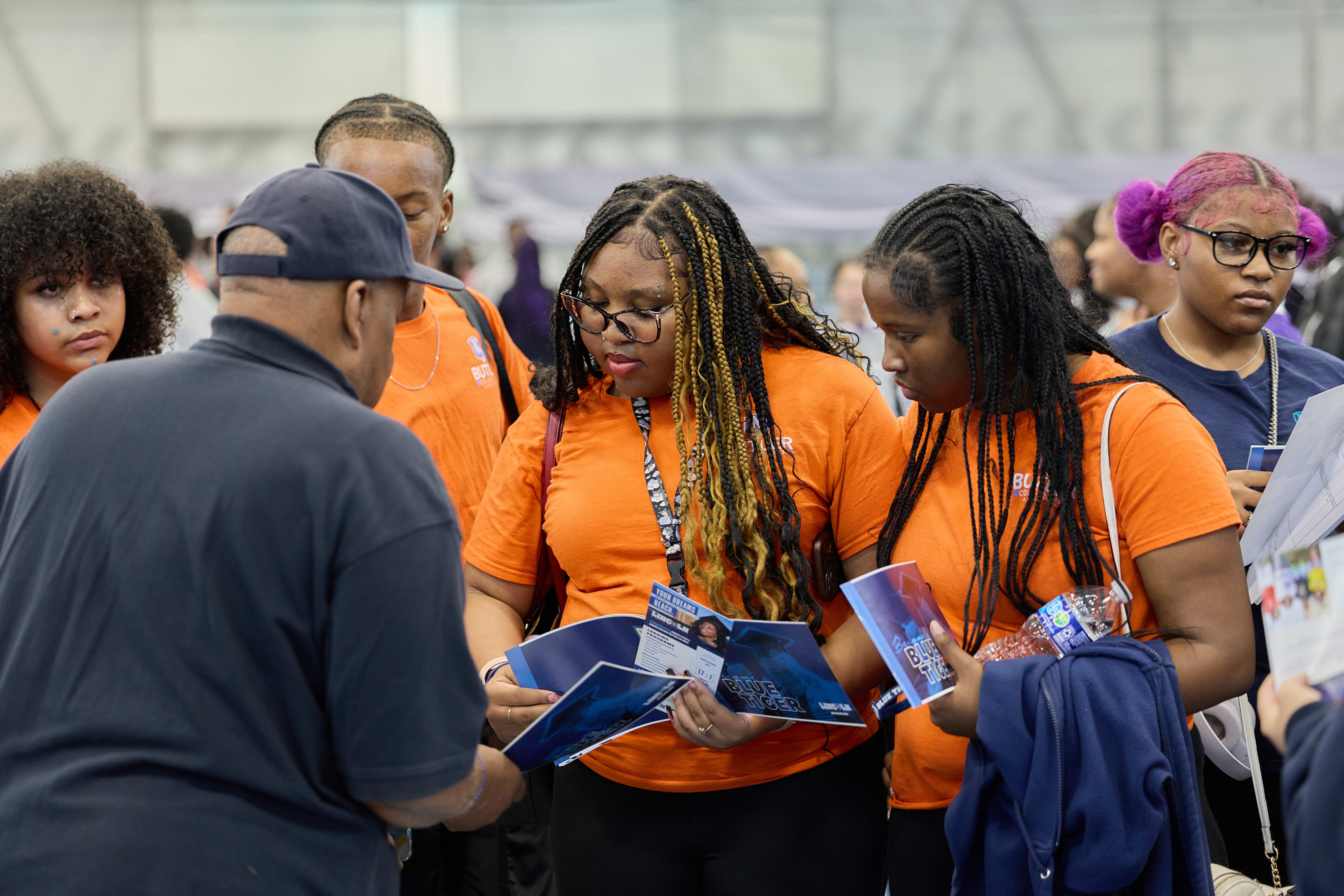 Group of Butler College Prep alumni talking with a college representative at the HBCU college fair