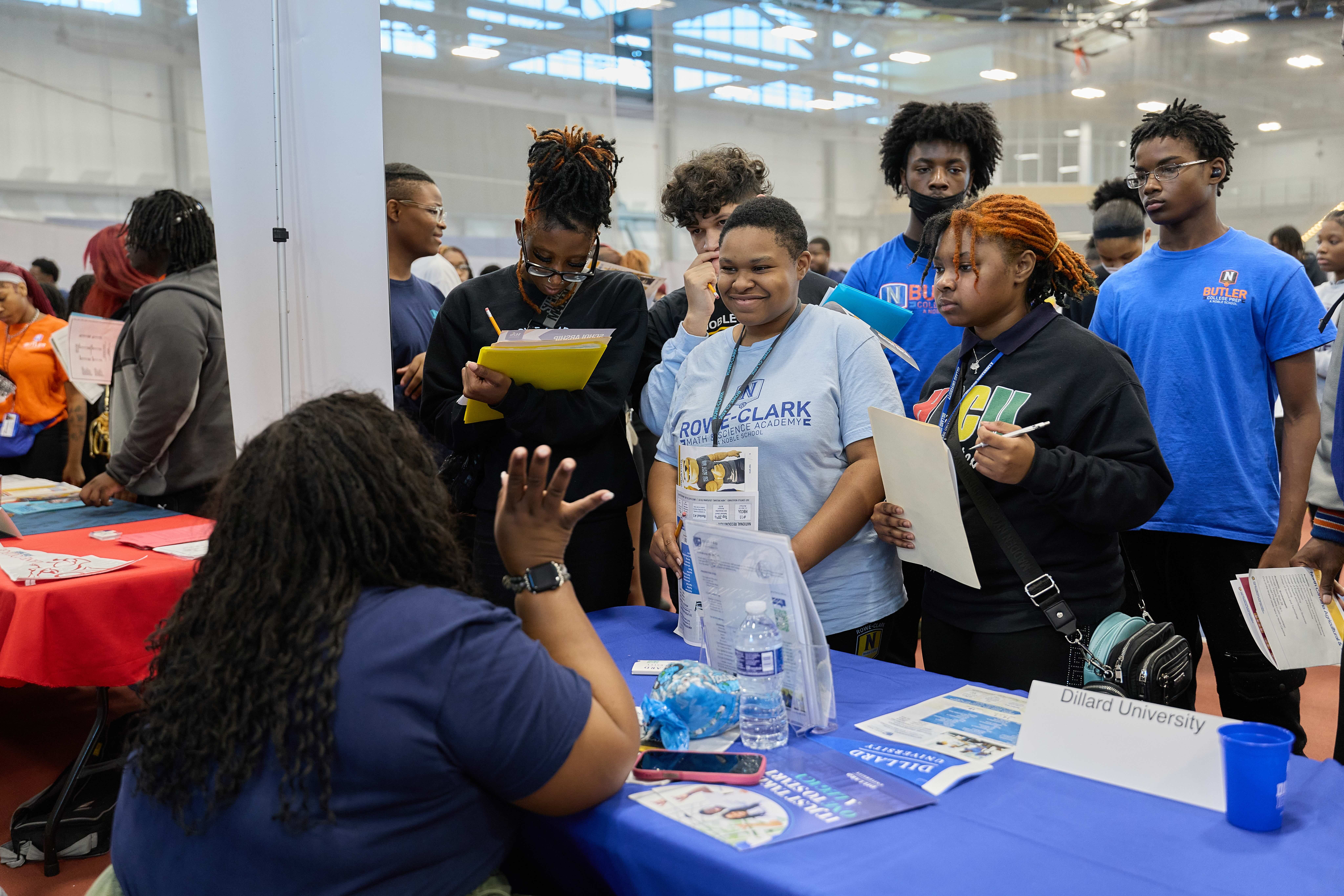 Two Rowe-Clark Math and Science Academy students talking to a college representative at HBCU college fair.