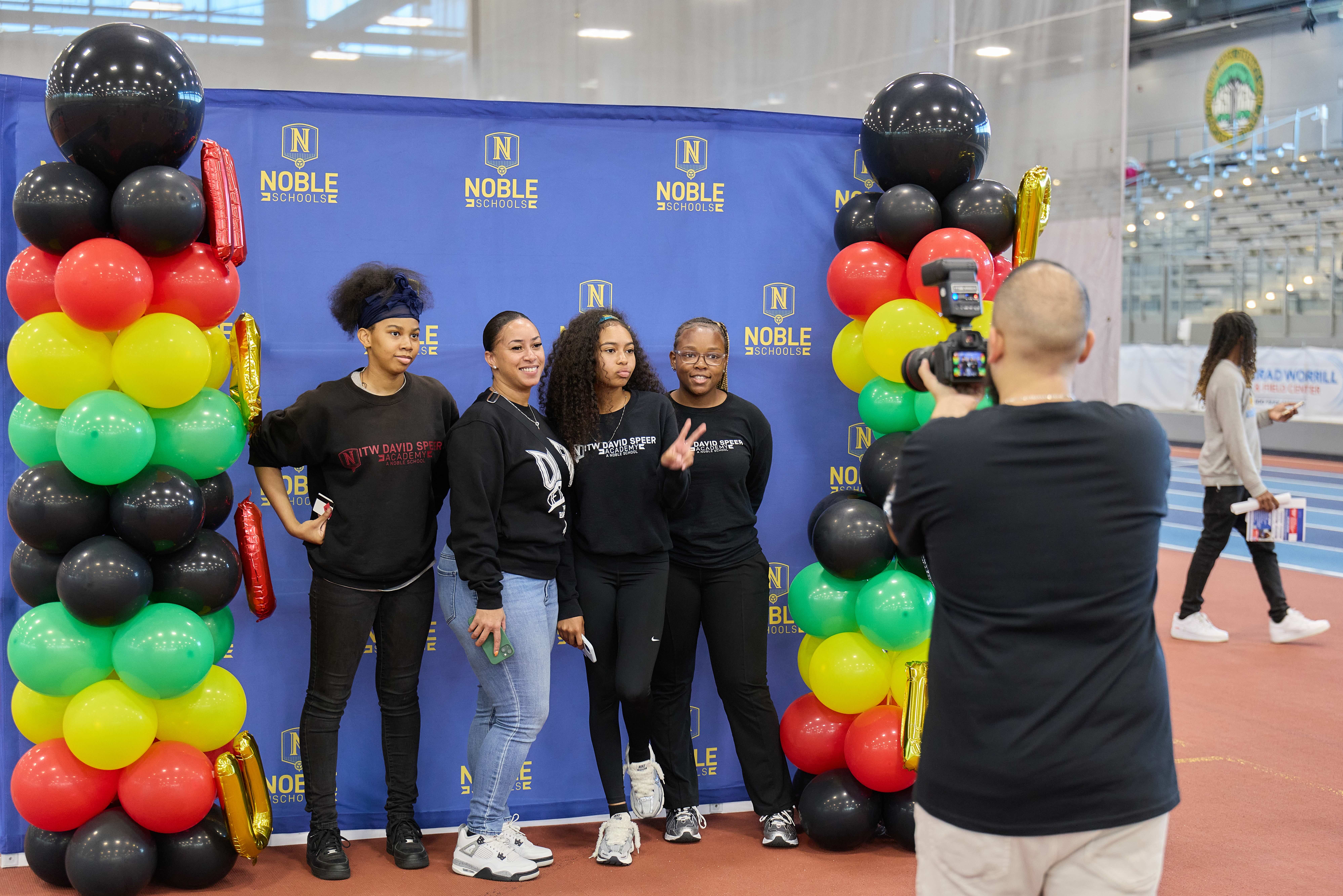 Four ITW David Speer Academy students getting their photo taken at a Noble booth at the HBCU College Fair.