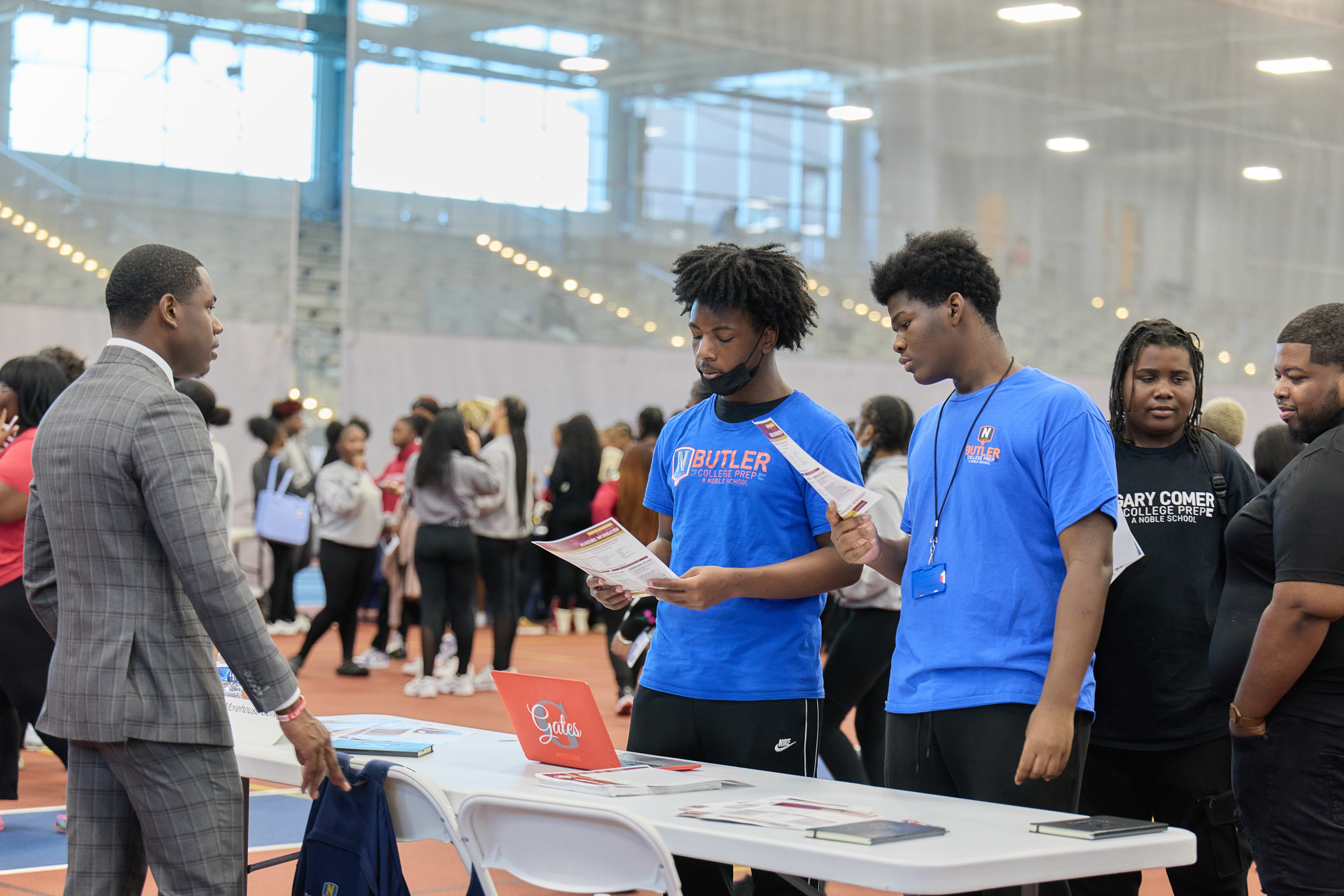 Two Butler College Prep students talking with a representative at the HBCU college fair.