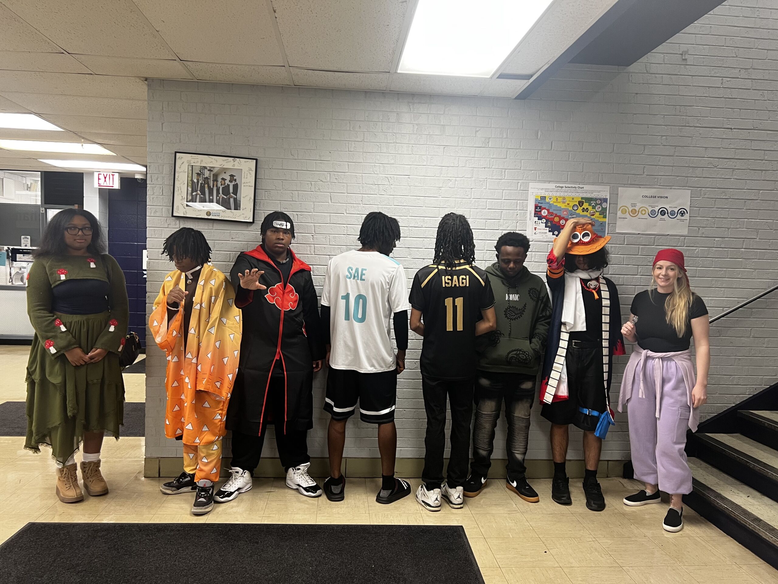 The Baker College Prep anime club poses in their costumes inside the school hallway.