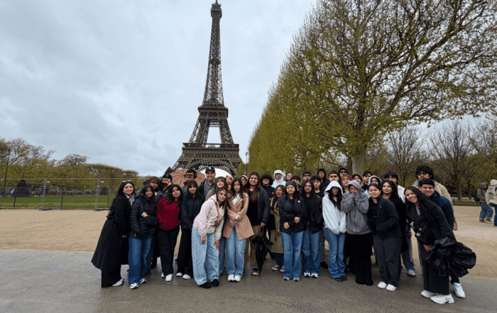 Mansueto High School students and staff pose for a group photo in front of the Eiffel Tower in Paris.